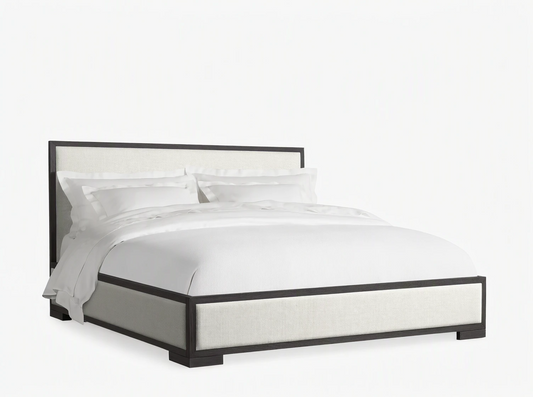 Darien Panel Bed with a dark wood frame and light upholstered panels, dressed with white bedding.