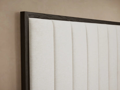 Darien Channel-Stitched Panel Bed with dark wood frame, cream channel-stitched headboard, white bedding, gray throw.