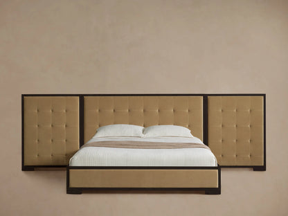 Darien Extended Box-Tufted Panel Bed with tan upholstered box-tufted headboard panels, dark wood frame, white bedding, on wood floor.