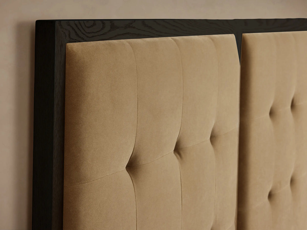 Darien Extended Box-Tufted Panel Bed with three tan upholstered, box-tufted panels & dark wood frame, white bedding.