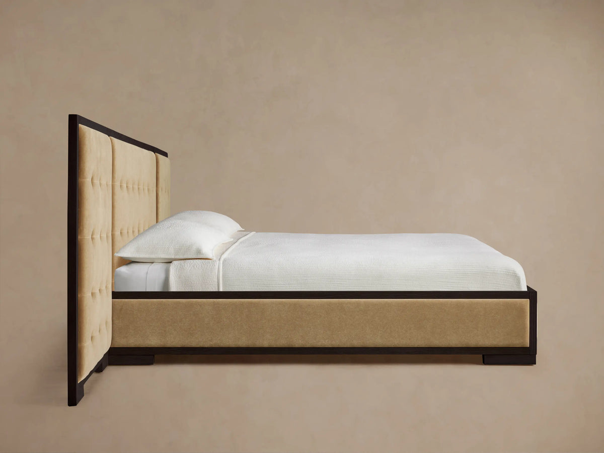 Close-up of Darien Extended Box-Tufted Panel Bed headboard with light beige upholstered panels and dark oak wood frame.
