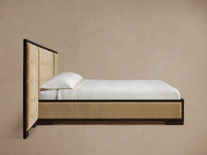 Close-up of Darien Extended Box-Tufted Panel Bed headboard with light beige upholstered panels and dark oak wood frame.