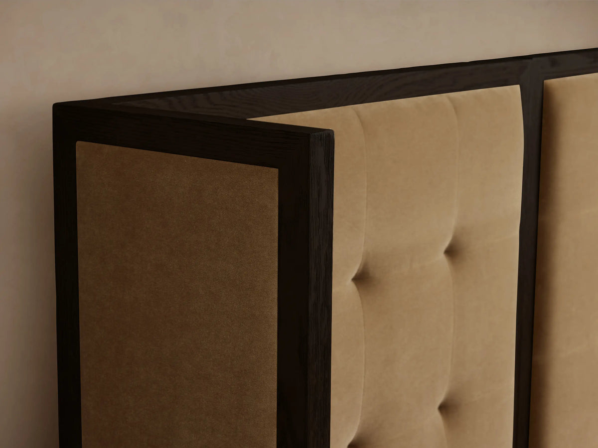 Darien Extended Box-Tufted Shelter Bed with dark wood frame, tan tufted upholstered panels, white bedding, and brown throw.