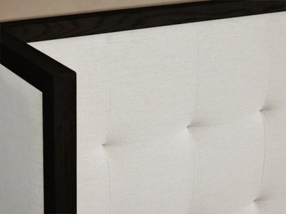 Darien Extended Box-Tufted Shelter Bed: black frame, white tufted panels creating an extended headboard, with white bedding.
