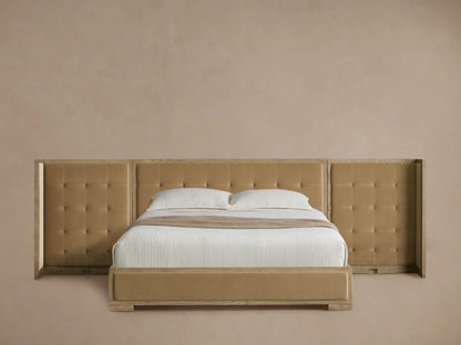 Darien extended shelter bed with light oak frame, camel box-tufted upholstery, white bedding, on a wood floor.
