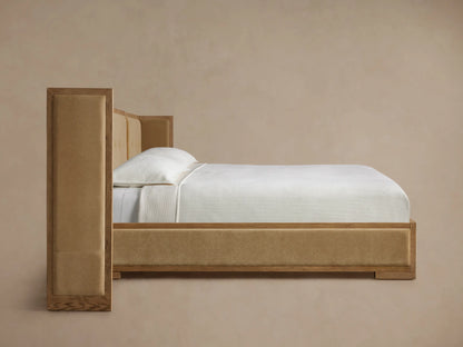 Close-up: Darien Extended Box-Tufted Shelter Bed headboard corner. Light oak frame, tan box-tufted upholstered fabric.