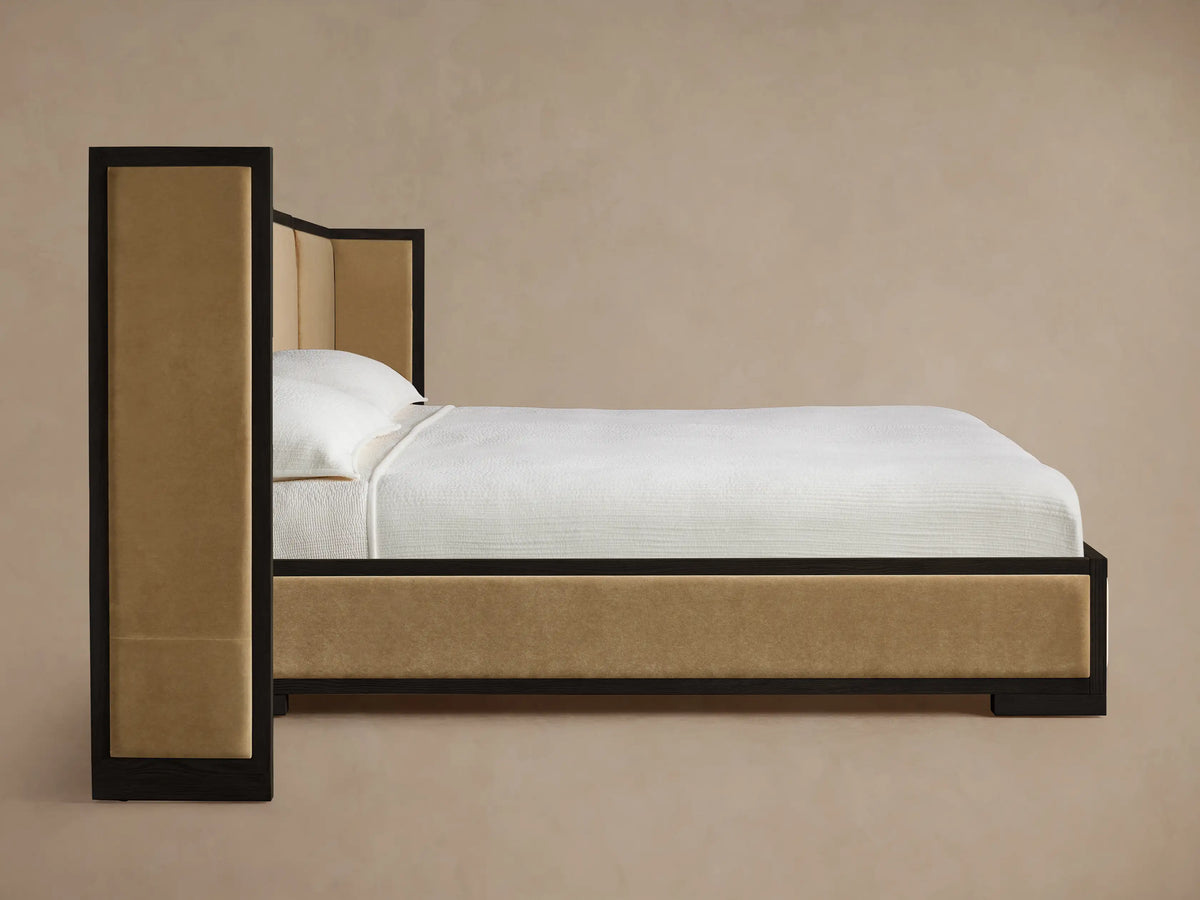 Close-up of Darien Extended Shelter Bed headboard corner with dark oak frame and light tan upholstered panels.