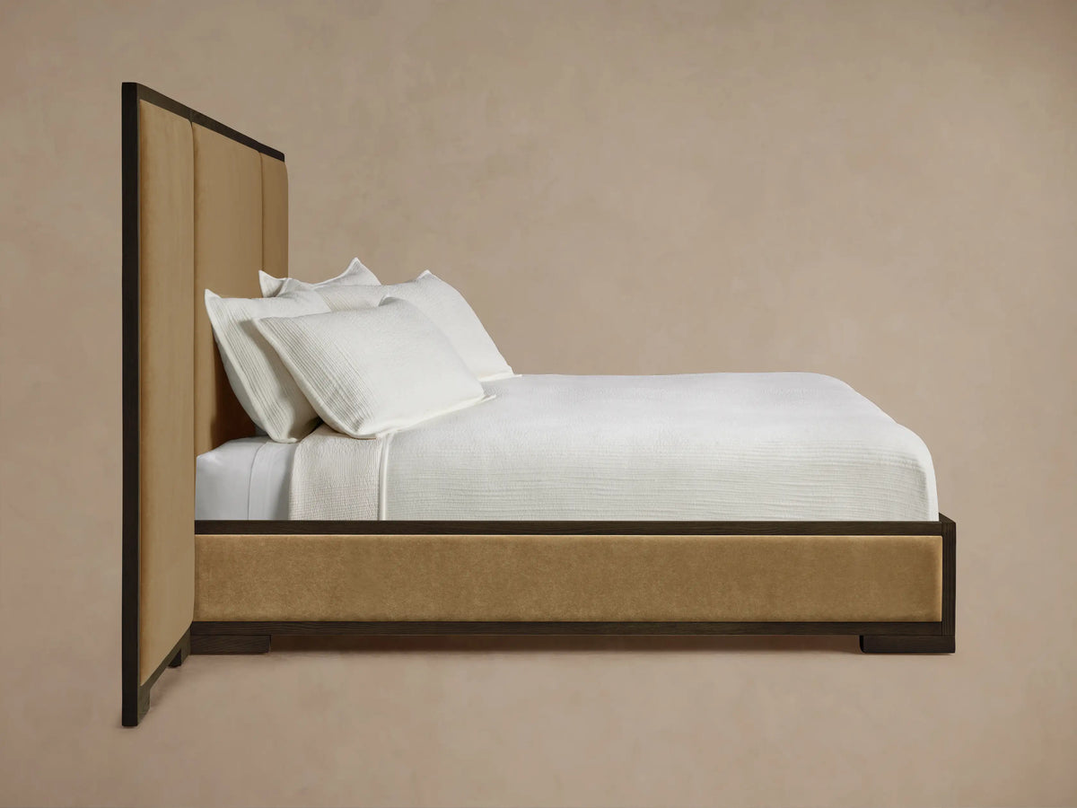 Darien Extended Panel Bed headboard, dark oak wood frame with visible grain, surrounding a tan upholstered panel.
