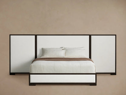 Darien Extended Panel Bed. Dark oak frame, extended white upholstered headboard, matching base, white bedding, brown throw.