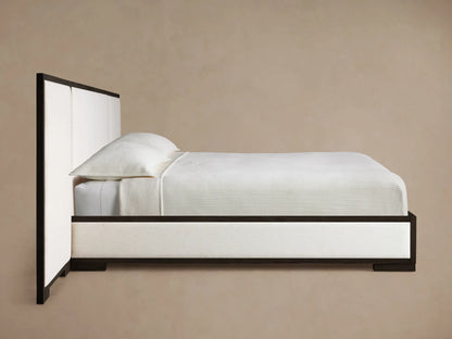 Close-up of Darien Extended Panel Bed's dark oak frame with visible grain texture and light beige upholstered panel.