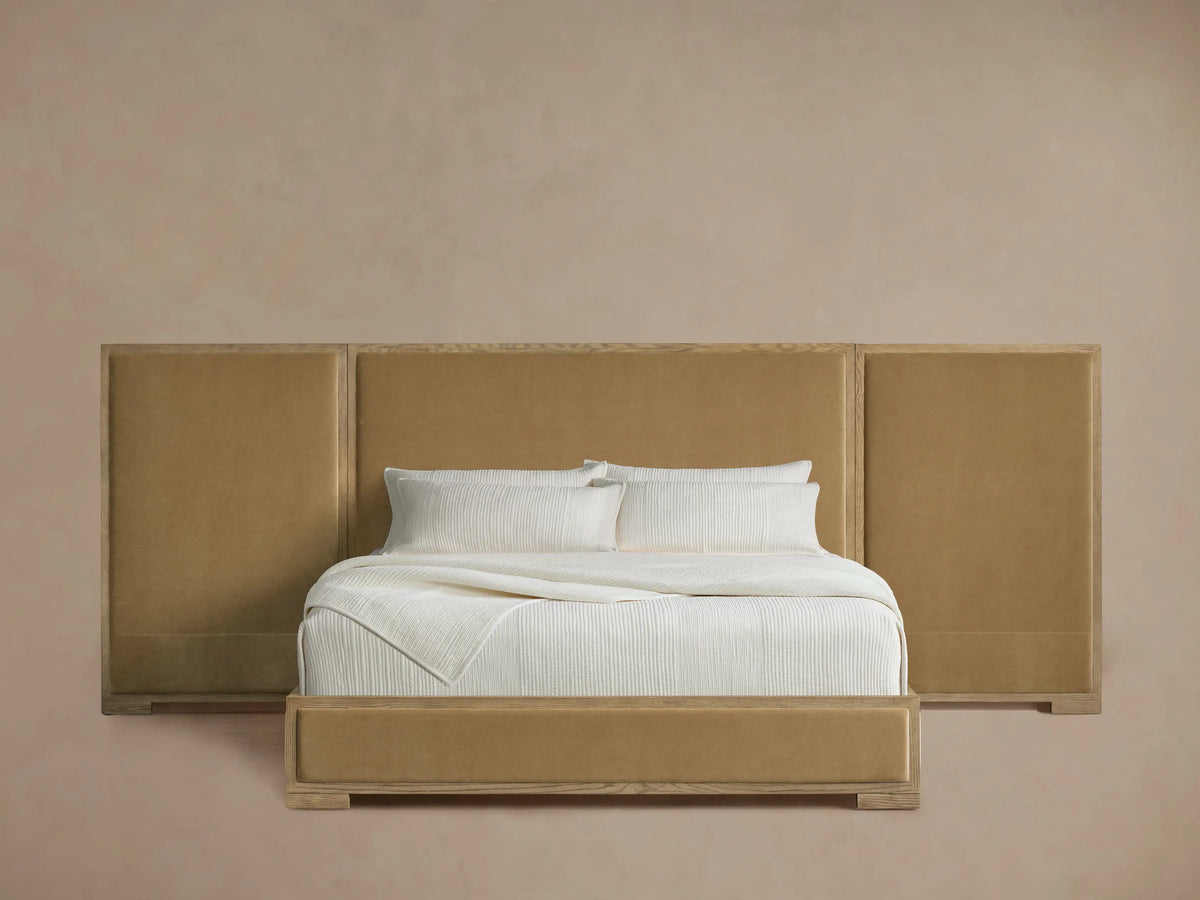 Darien extended panel bed with oak frame, tan upholstered headboard & bed frame. Crisp white bedding.