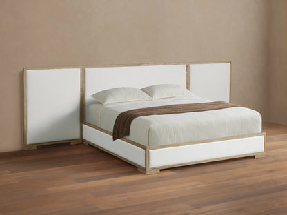 Darien Extended Panel Bed: light oak frame, white upholstered extended headboard & base, white bedding, brown throw on wood floor.