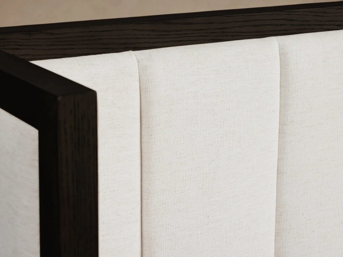 Darien Extended Channel-Stitched Shelter Bed with white upholstered headboard and side panels, dark wood frame, white bedding and throw.