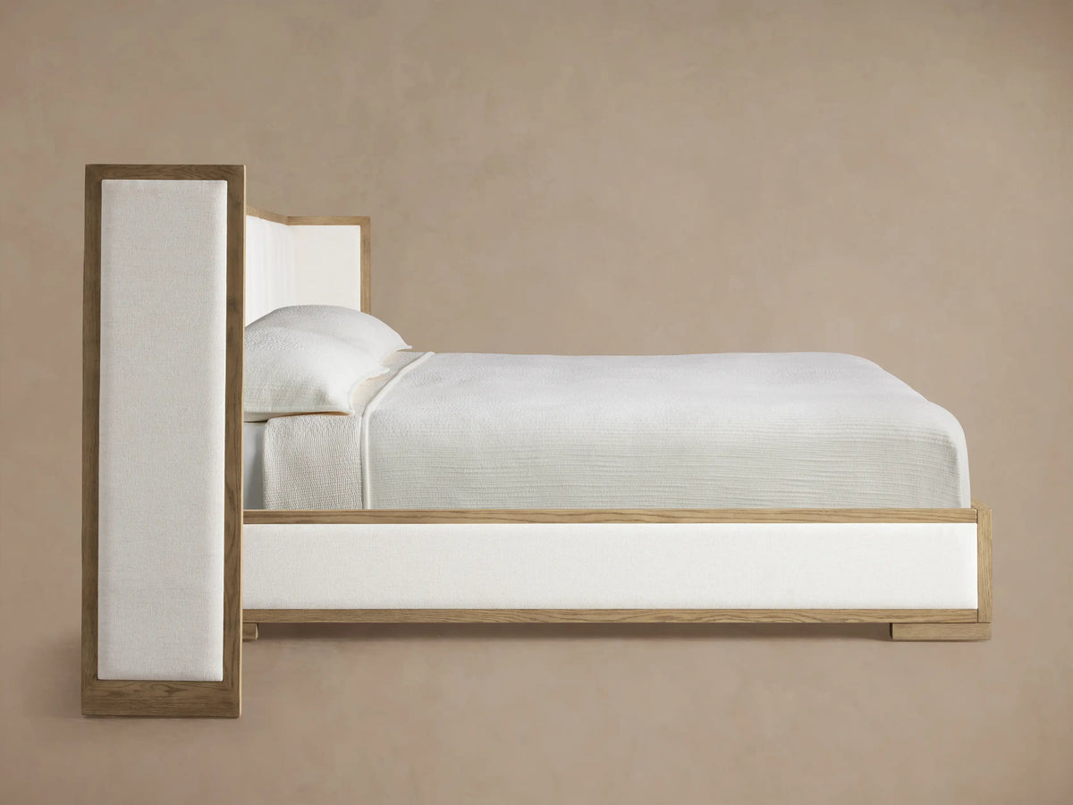 Darien Extended Shelter Bed corner detail: light oak wood frame and textured cream channel-stitched upholstery.