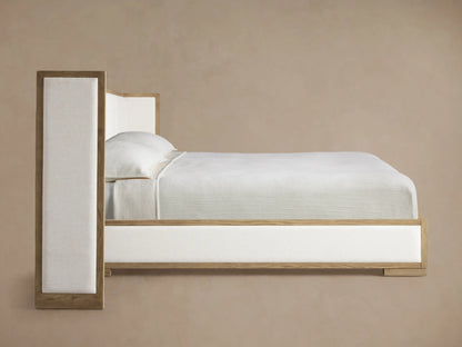 Darien Extended Shelter Bed corner detail: light oak wood frame and textured cream channel-stitched upholstery.
