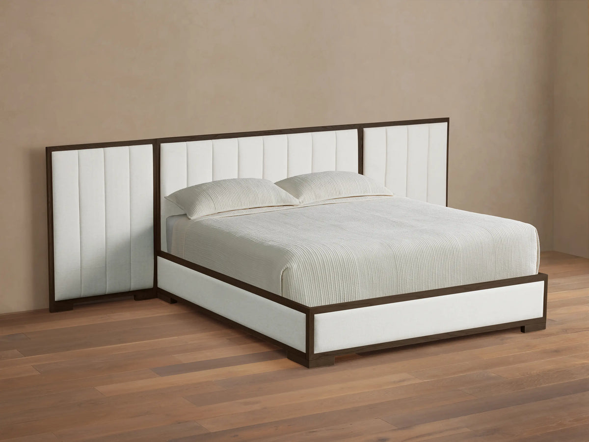 Front view of the Darien Extended Channel-Stitched Panel Bed, featuring a brown wooden frame and white channel-stitched upholstered panels, with white bedding.