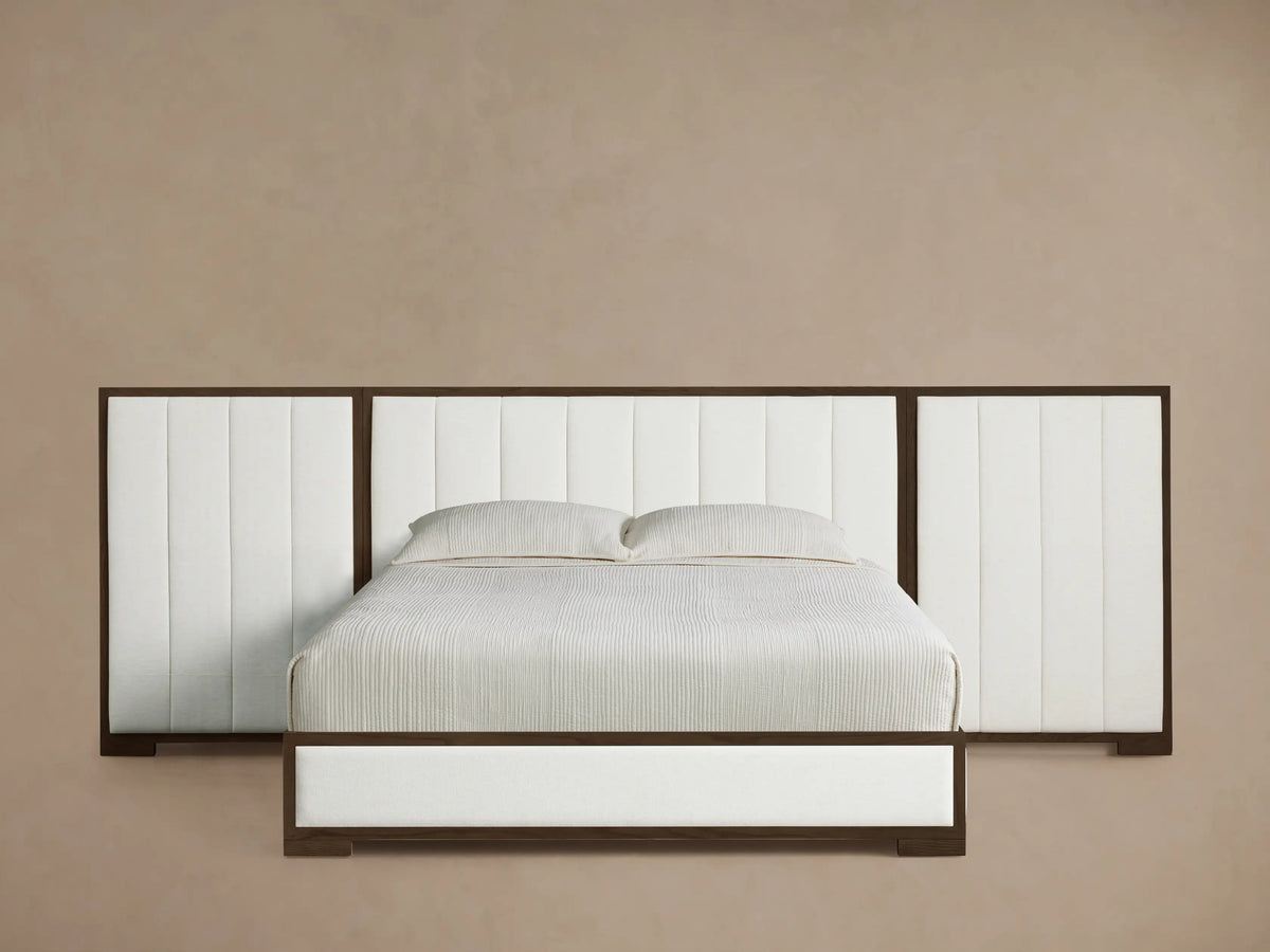 Front view of the Darien Extended Channel-Stitched Panel Bed featuring white channel-stitched upholstered panels and a dark wood frame.