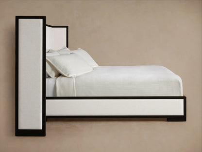 Close-up of Darien Extended Shelter Bed headboard with dark wood frame and light cream box-tufted fabric.