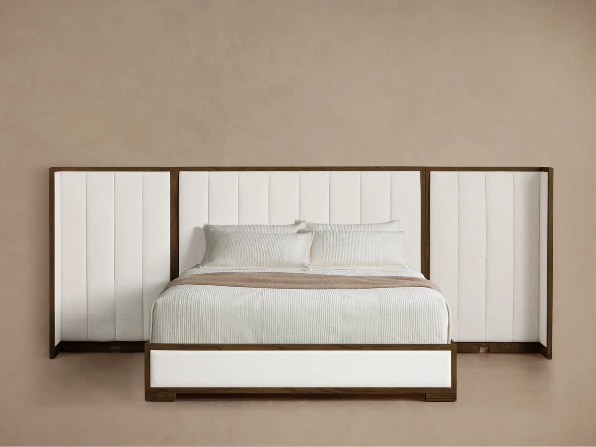 Front view of the Darien Extended Channel-Stitched Shelter Bed with white upholstered panels, dark oak frame, and white bedding.