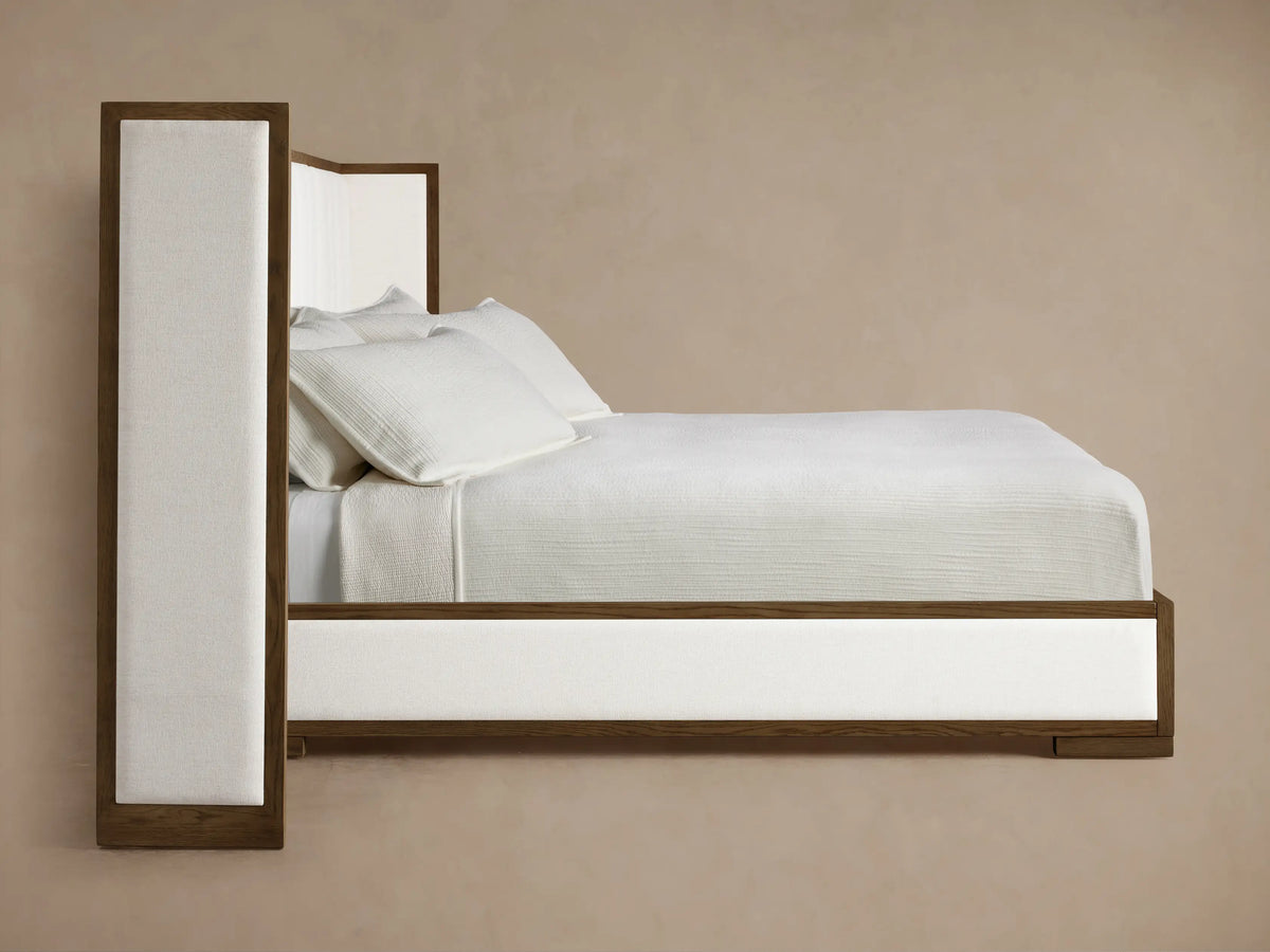Front view of the Darien Extended Channel-Stitched Shelter Bed with white channel-stitched upholstery and dark brown wood frame.