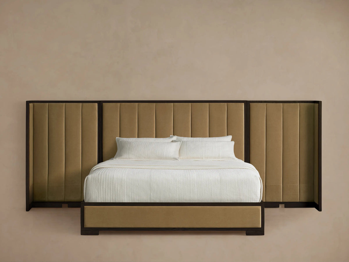 Darien extended shelter bed with dark oak frame, light brown channel-stitched upholstered headboard, and white bedding.