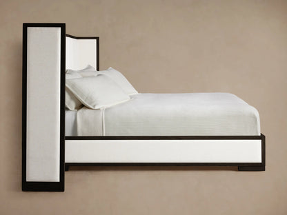 Close-up of Darien Shelter Bed headboard: dark oak frame borders light cream, textured channel-stitched upholstered panels.