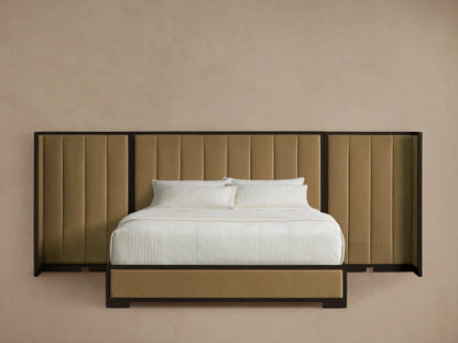 Darien Extended Shelter Bed with tan channel-stitched upholstery, dark wood frame, and white bedding, on a wooden floor.