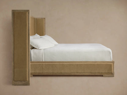 Close-up of a bed headboard corner. Features light brown wooden frame with visible grain & vertical channel-tufted beige velvet upholstery.