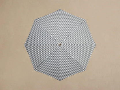 Close-up of the White Ruffled Parasol Base, showing its pleated design, cylindrical white pole, and wooden insert.