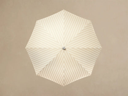 Front view of a cream and white striped parasol with a cream fringe and a light wood pole.