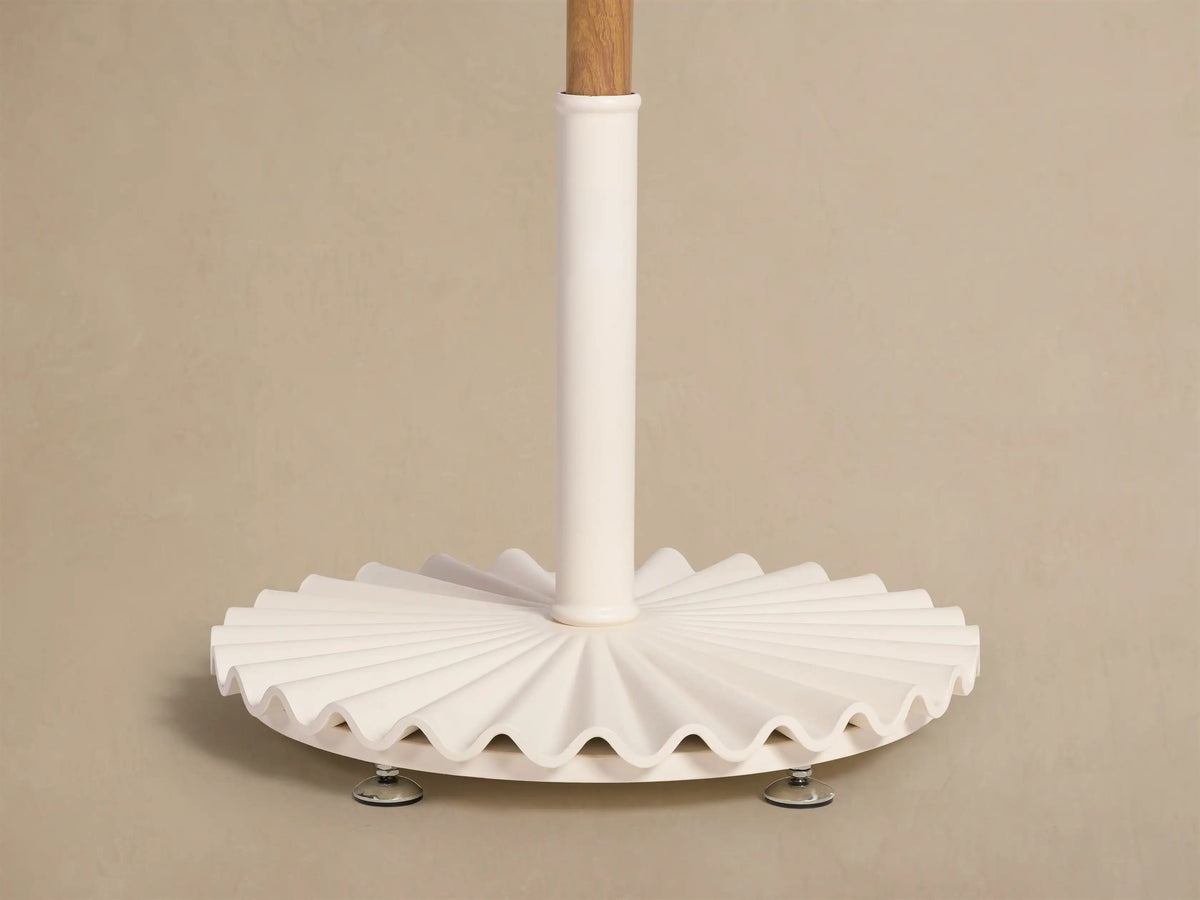 Top view of a Cream Umbrella with a metallic finial and decorative fringe along the canopy edge.