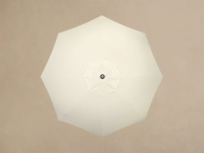 Front view of a white ruffled, pleated base with a cylindrical stem, rising to a light wood pole.