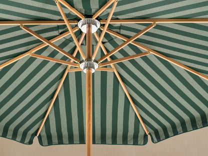 Front view of a patio umbrella with a green and white striped scalloped canopy, wooden pole, and white decorative base.