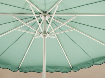 Front view of a light green patio umbrella with a dark green wavy trim and a white pole and base.