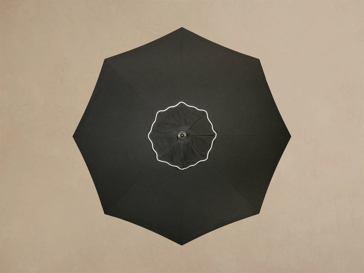 Close-up of the cream Round Lamp Base, showing its multi-layered design and a central pole extending upwards.