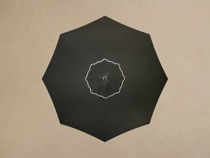 Close-up of the cream Round Lamp Base, showing its multi-layered design and a central pole extending upwards.