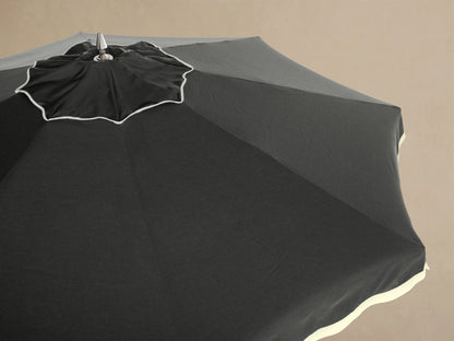 Interior view of a black patio umbrella, showing the natural wood frame, radiating ribs, and silver metal connectors.