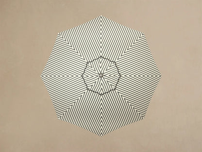 Close-up of the off-white round umbrella base with concentric rings, a cylindrical pole, and silver adjustable feet.