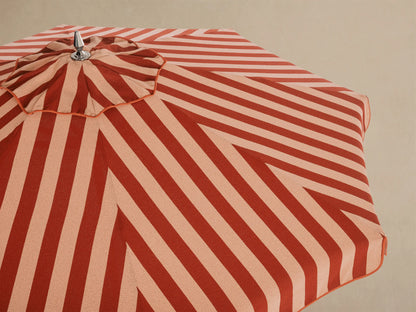 Interior view of a red and light beige striped umbrella, featuring white ribs, a white central pole, and silver mechanism.