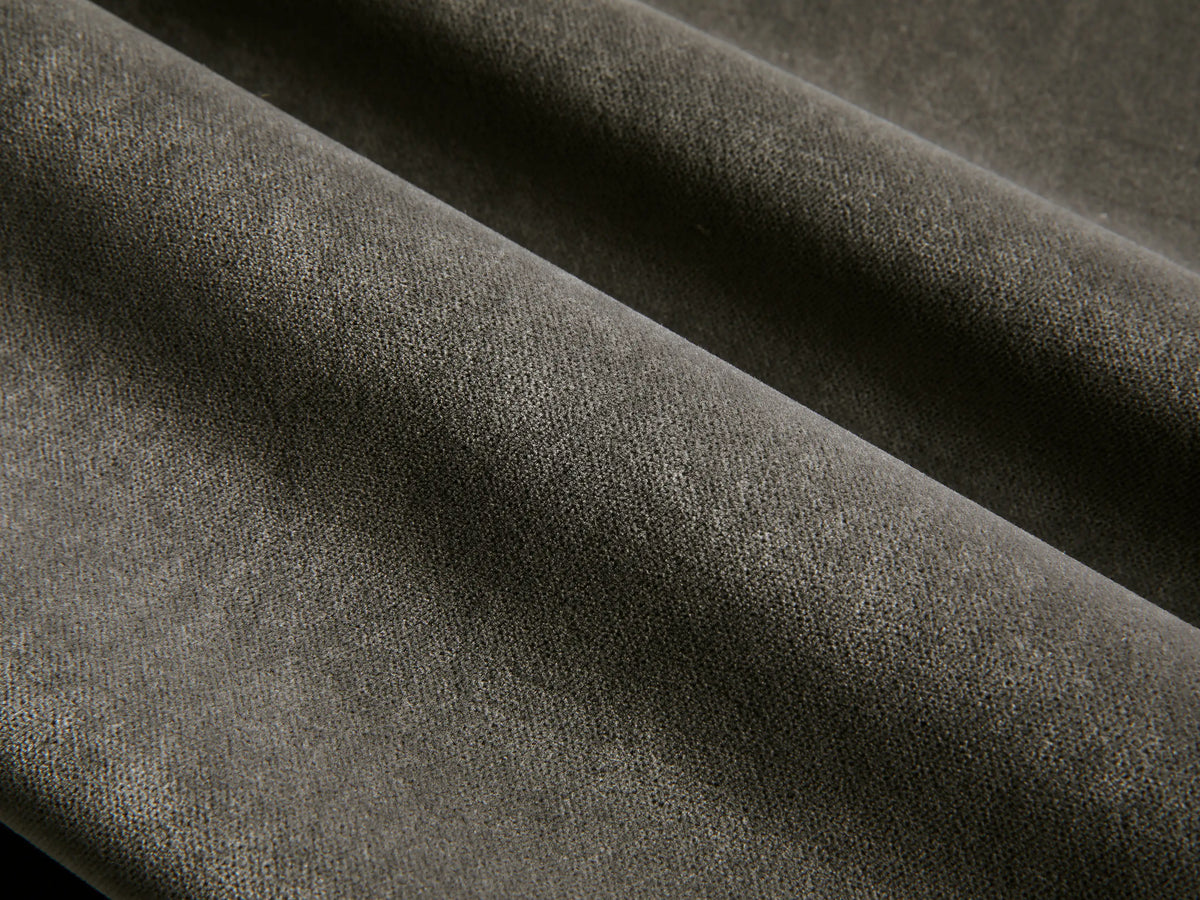 Front view of the Deacon Ottoman with a dark gray cushion and a brushed steel swivel base.