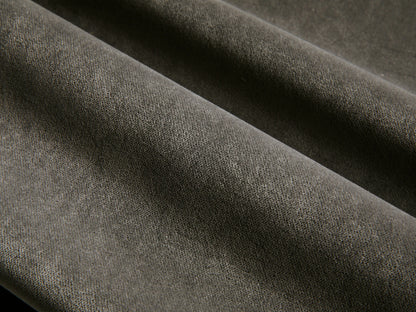 Front view of the Deacon Ottoman with a dark gray cushion and a brushed steel swivel base.