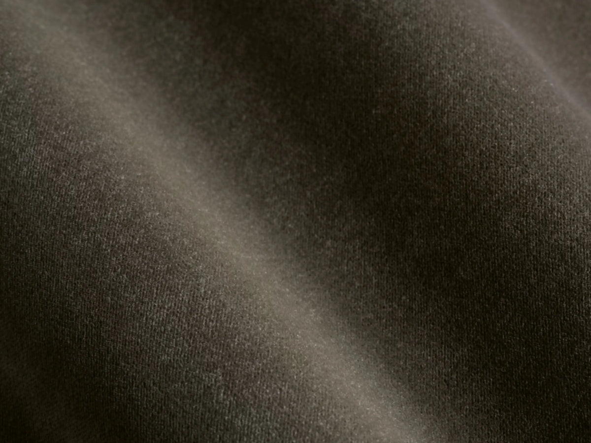 Front view of the dark olive green velvet Deacon Ottoman.