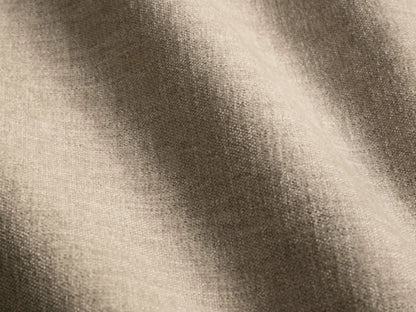 Front view of a cream-colored, rectangular Deacon Ottoman cushion with a textured fabric weave.