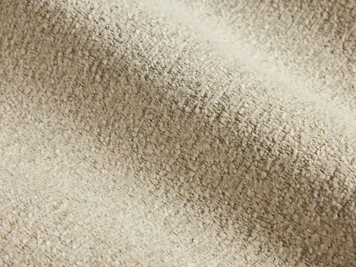 Overhead view of the square cream Deacon Ottoman, featuring a subtly textured upholstery fabric.