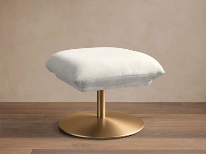 Front view of the light grey Deacon Ottoman, featuring a rectangular upholstered cushion and a brushed gold circular base.