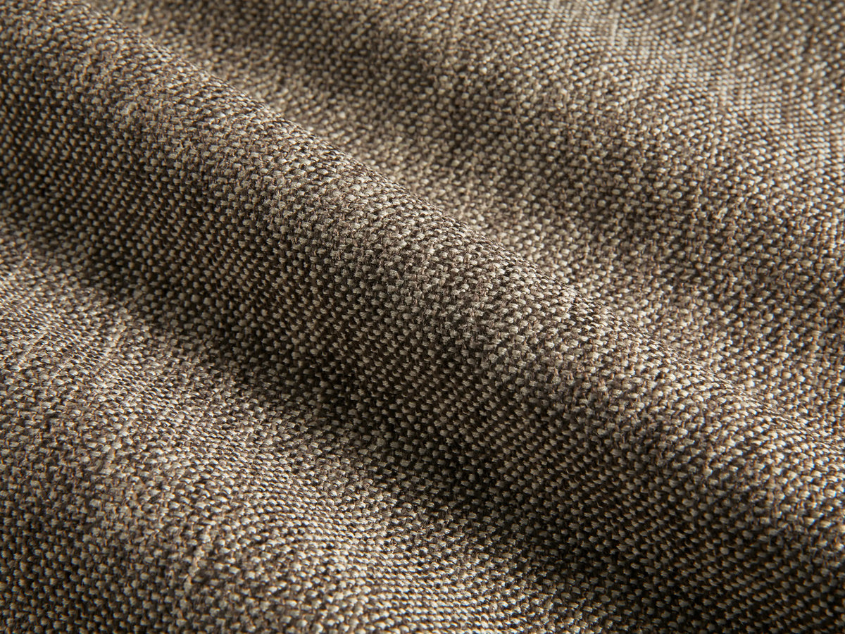 Close-up of the brown woven upholstery fabric on the Deacon Ottoman.