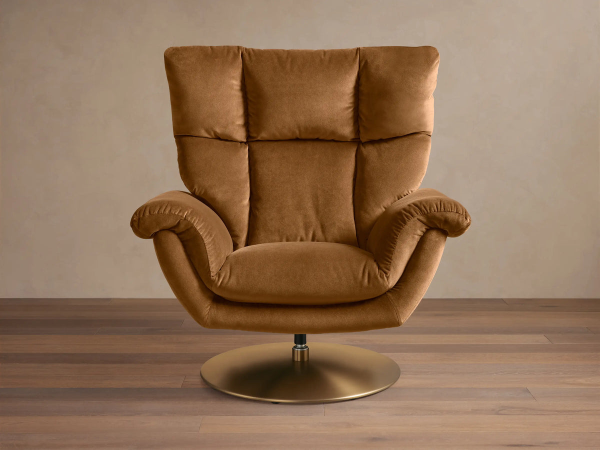Side-front view of a partially reclined brown Deacon Swivel Recliner, featuring a plush channel-tufted back and gold swivel base.