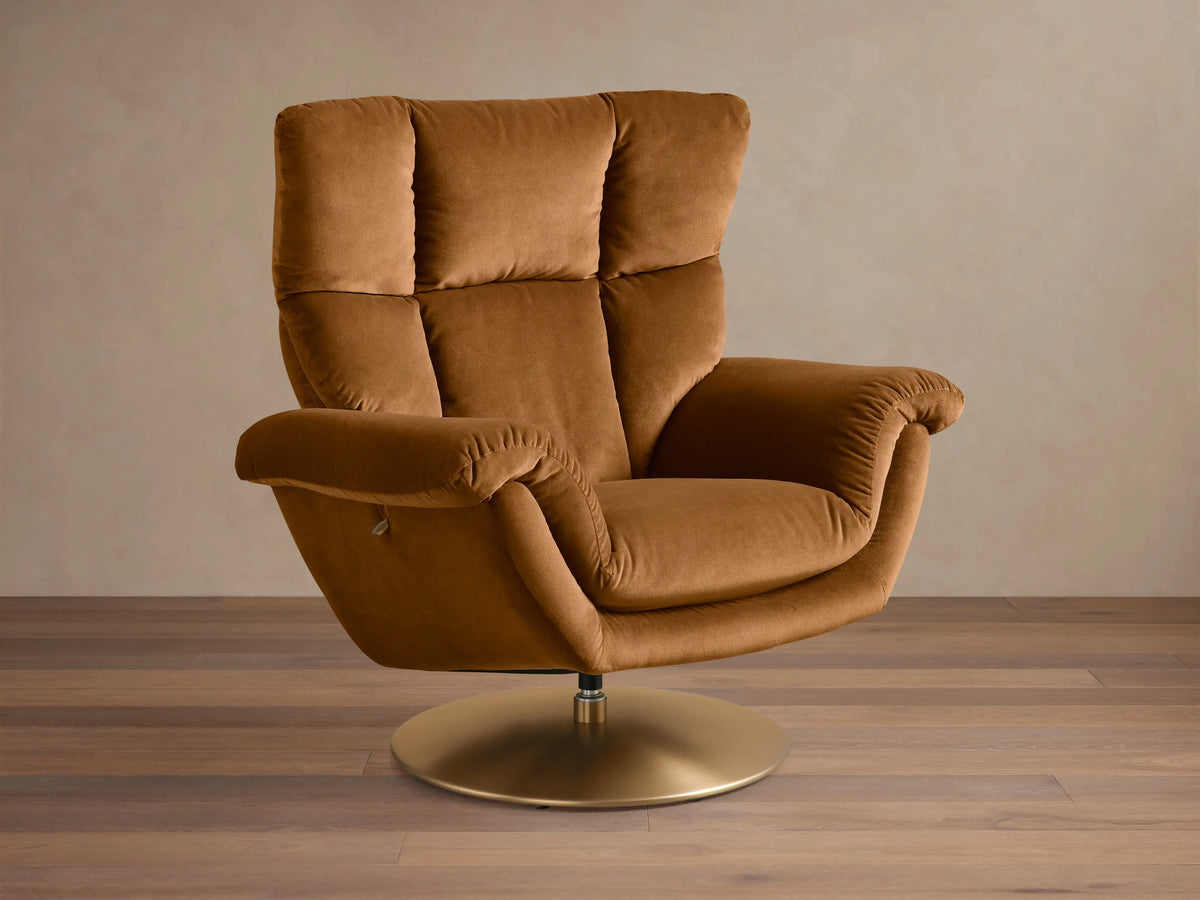Front view of the brown Deacon Swivel Recliner with a plush, tufted back, rounded arms, and a round gold swivel base.
