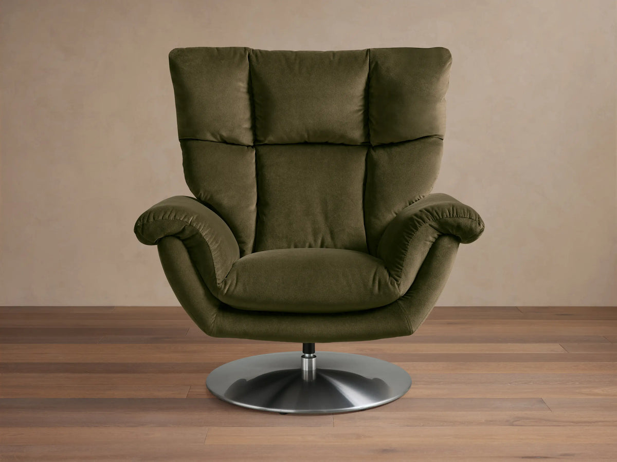 Front view of a dark olive green plush Deacon Swivel Recliner, featuring a quilted back, rolled arms, and a stainless steel swivel base.