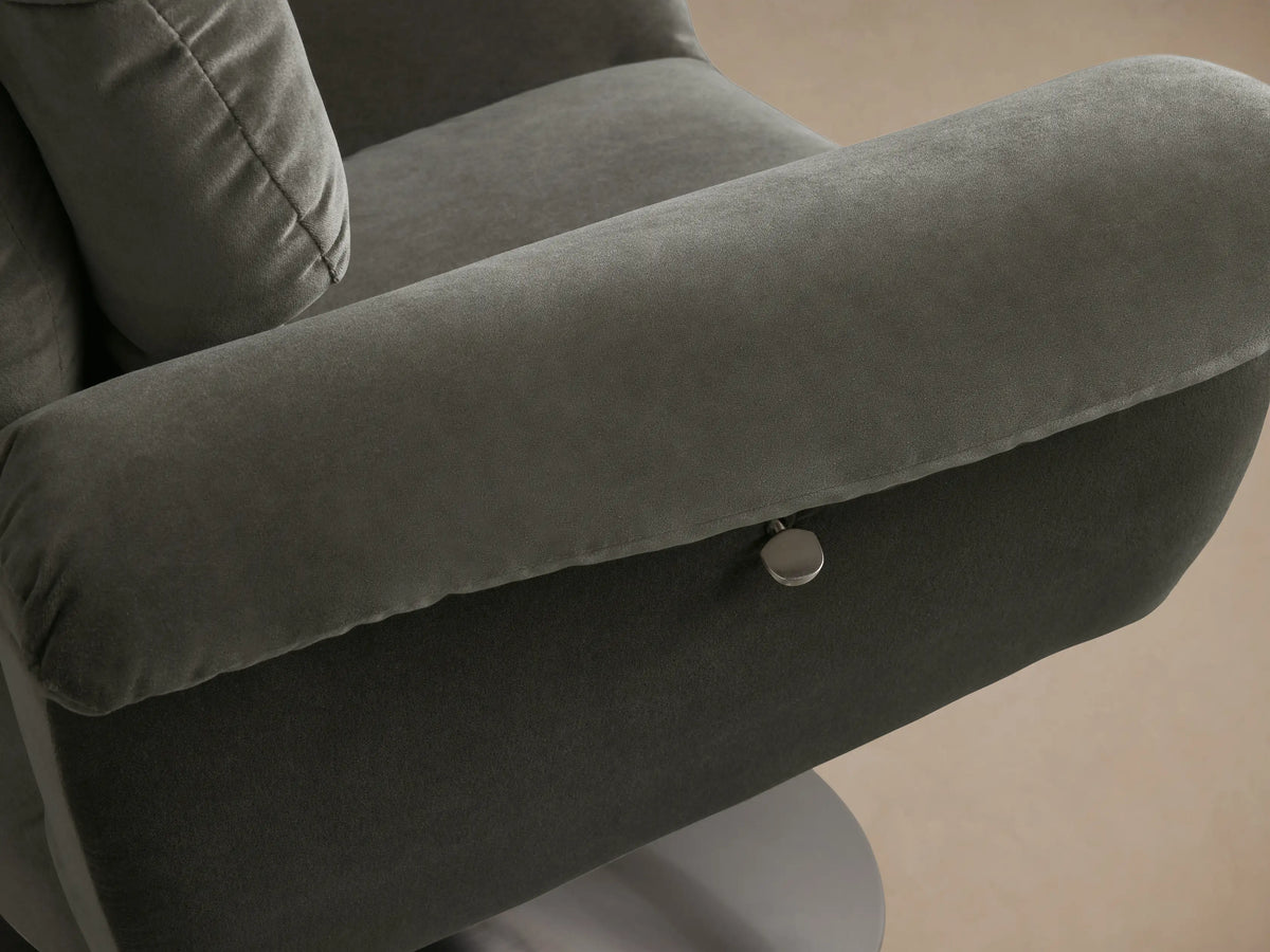 Front view of the dark gray Deacon Swivel Recliner with plush cushioning, rolled armrests, and a round silver swivel base.